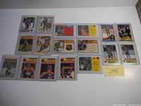 Top-down photo showing 17 Wayne Gretzky OPC cards laid flat on a white surface, all in protective sleeves. Cards show a range of poses and years, mainly from the 1980s.