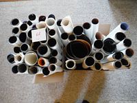 Two boxes packed with rolled vintage posters.