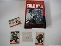Photo showing the Roy MacSkimming book and three hockey trading cards with a card number 77 included.