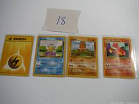 Four Pokemon cards lined up showing front sides: Lightning Energy, Squirtle, Diglett, and Charmander.