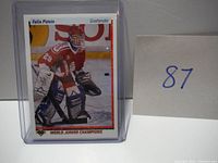 Front photo of the Felix Potvin rookie hockey card in protective casing showing him in goalie gear on ice with World Junior Champions label.