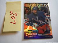 Front image of 1999 Wayne Gretzky hockey card showing him in a New York Rangers uniform with 'GRETZKY FOR THE RECORD' branding and Record 3.