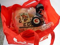 Photo showing tote bag containing rookie card, signed hockey puck, and collectible figure