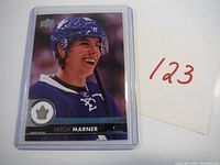 Front of the Mitch Marner rookie hockey card showing player smiling in Toronto Maple Leafs uniform, card number 174 in upper left corner.