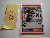 Photo of the front side of the 1990 Score Wayne Gretzky hockey card with the title 'Magician' showing Gretzky in action.