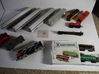 Full view of all train cars and boxed streetcars showing variety and condition