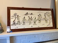 Full front view of the framed Asian wall art depicting multiple figures and outdoor scene.