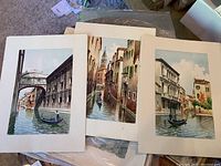 Three watercolor prints of Italian canal scenes with gondolas and Italian architecture.