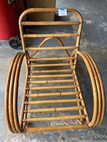 Full view of bamboo armchair frame showing horizontal bamboo slats and curved armrests