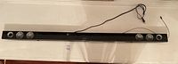 Full length view of the Sharp HT-SB60 soundbar showing its slim black body and speakers.