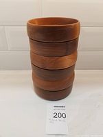 Stack of six wooden salad bowls showing general condition and height.