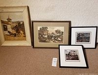 Overview of all main framed artworks laid on floor including original bullfighter painting, Currier & Ives lithograph, and 2 smaller framed prints.
