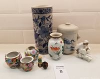 Front view of all items showing their sizes and details with a hand for scale