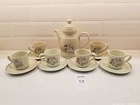 Full tea set displayed: 1 teapot with lid, 6 cups, 6 saucers.