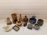 View of all pottery items and wood bowl together