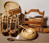 All wooden items grouped showing bowls, candle holders, box, magazine rack, and cast iron deer plaque.