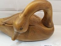 Close-up of goose head showing wood grain and carving detail