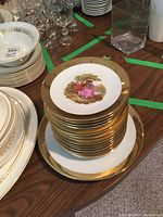 Stack of plates showing the large Bavaria plate with central artwork and gold trim on top of a larger plate.