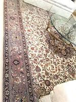 Full view of rug under glass coffee table and white sofa