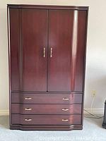 Front view of TallBoy furniture piece showing double doors and drawers with brass handles.