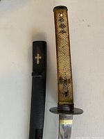 Handle removed from scabbard showing shagreen (ray skin) covering and metal mouth collar
