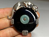 Front view of panther motif and central jade rondelle on onyx disc