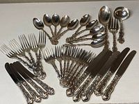 Full layout of 32 pieces: forks, knives, tablespoons, teaspoons