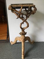 Full front view of the table showing gilt wood base and marble top