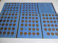 Six album pages showing pennies in date-and-mint-mark labeled slots from 1941 through 1976, including steel WWII cents.