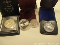 All four coins displayed in their respective presentation cases