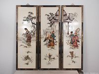 Front view of all three wooden panels showing painted detailed Asian traditional figures and scenery, black border with gold designs.