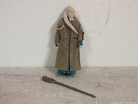 Front view of Biba Fortuna action figure with original staff laid on the floor