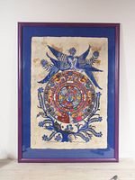 Full view of framed art print showing the entire fabric art with blue birds, circular colorful design and floral details within a purple wooden frame.
