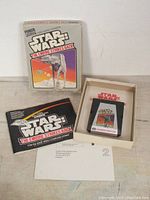 Original Atari Star Wars The Empire Strikes Back game box showing front cover, manual, mail-in card, and insert inside box