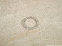 Full view of vintage sterling silver wrap around band ring with clear stones on the surface.