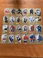 24 hockey cards from 2008-09 Fleer Ultra Gold Medallions series laid out in rows, showing player action shots against gold medallion background.