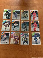 Top-down view of 12 individual hockey cards from 1978-79 OPC featuring different players in various team uniforms.