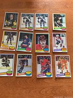 Front view of 12 hockey cards from 1980-81 season with player images in team uniforms.