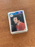 Stack of OPC hockey cards with top card showing Brad Park in Detroit Red Wings jersey.