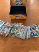 Box labeled Prestige 950 football cards with over 60 cards spread in front