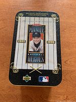 Front view of rectangular tin box featuring Mickey Mantle baseball hero theme from 1996 Upper Deck Metallic Impressions series