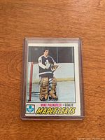 Front side of 1977-78 O-Pee-Chee Mike Palmateer rookie hockey card showing player standing in goalie gear with Toronto Maple Leafs logo.