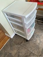 White plastic drawer container on wheels, showing top and side view