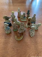 Photo showing all 15 Wade England Red Rose Tea figurines grouped on a table, depicting nursery rhyme characters including children, animals, and objects.