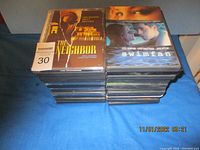 Front view of two stacks of DVD movies, showing titles 'The Neighbor' and 'Swimfan'.