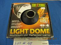 Photo of the front of the Exo Terra Light Dome Aluminum UV Reflector Lamp packaging showing product name and UVB compatibility details.