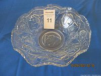 Top view of clear glass bowl showing ruffled edge and embossed Roses in the Snow floral pattern.