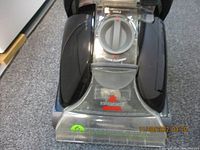Close-up front view showing Bissell logo and dial controls for floor cleaning.