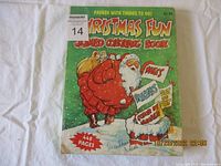 Front cover of the Christmas Fun Jumbo Coloring Book featuring Santa Claus and text about included activities such as puzzles, color-by-numbers, and dot-to-dot. Shows condition and cover details.