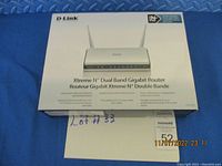 Photo of the router's original retail box showing D-Link logo, model DIR-655, product name Xtreme N Dual Band Gigabit Router.